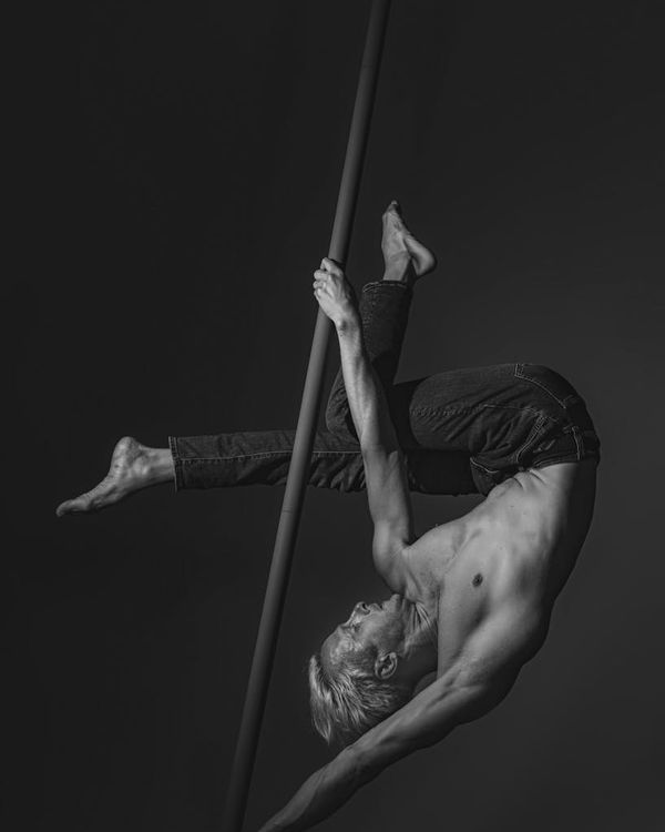 Man performing a controlled strength exercise in a minimalist gym setting.